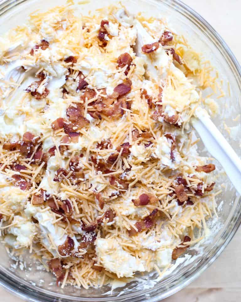Mixing ingredients together for Cheesy Bacon Potato Casserole