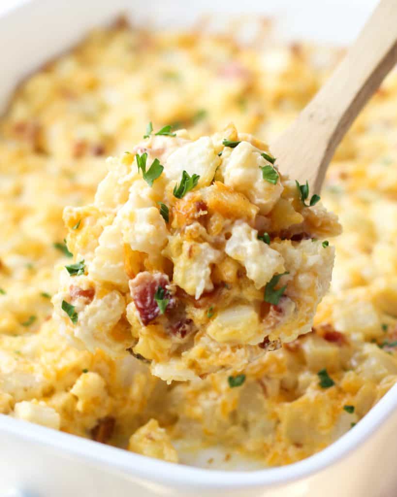 Scooping out some Cheesy Bacon Potato Casserole