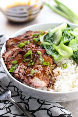 Chinese Barbecue Pork (char Siu) and Bok Choy Rice Bowl with a small bowl of sauce in the background
