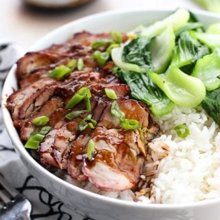 Chinese Barbecue Pork (char Siu) and Bok Choy Rice Bowl with a small bowl of sauce in the background