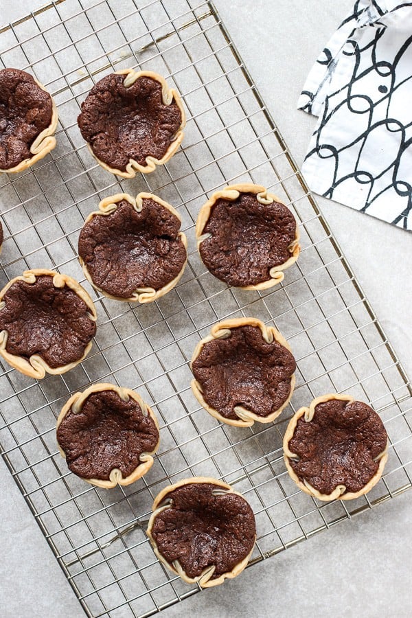 Cooling a batch of freshly baked Mini Chocolate Chess Pie on baking rack