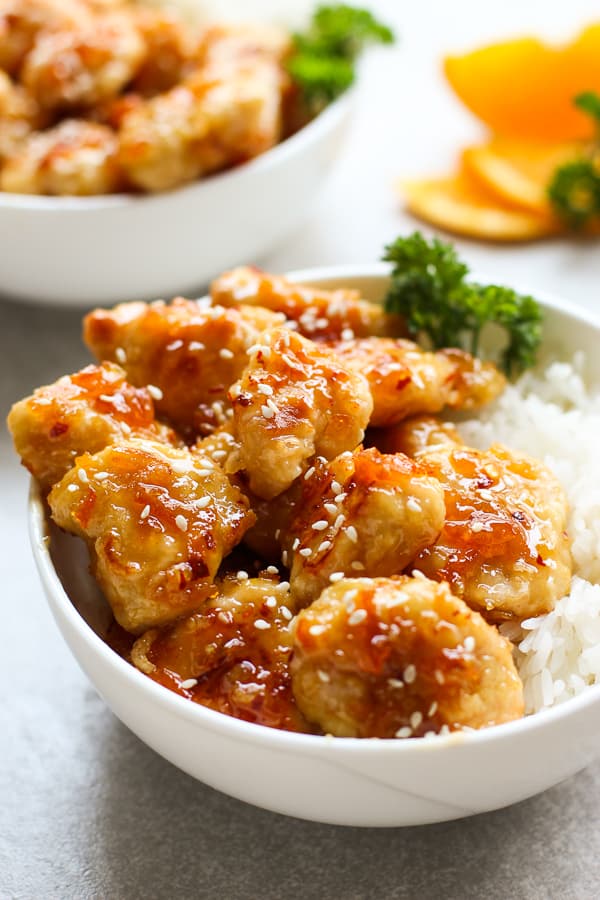 A bowl of Easy Baked Orange Chicken on top of rice