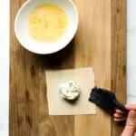 brushing side of wonton wrapper with egg wash