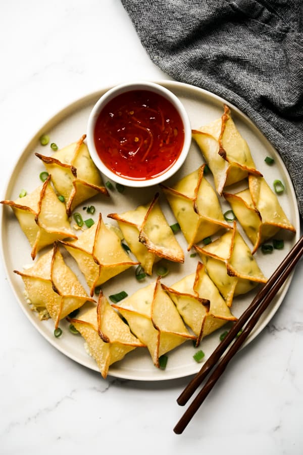 top down view of a plate of Baked Cream Cheese Rangoons and sauce