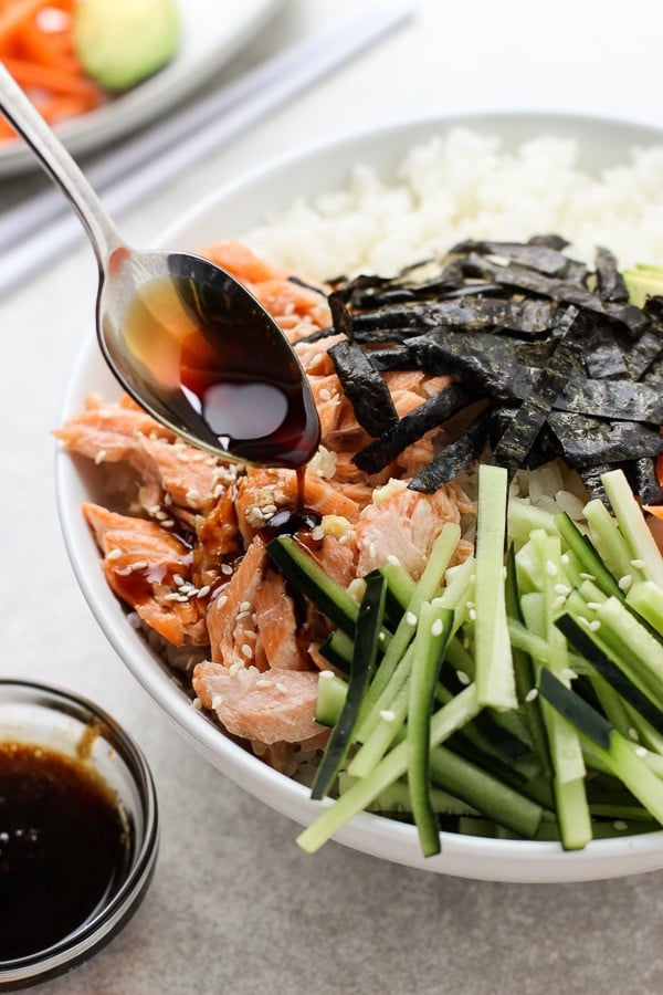 Adding sauce to Deconstructed Baked Salmon Sushi Bowl