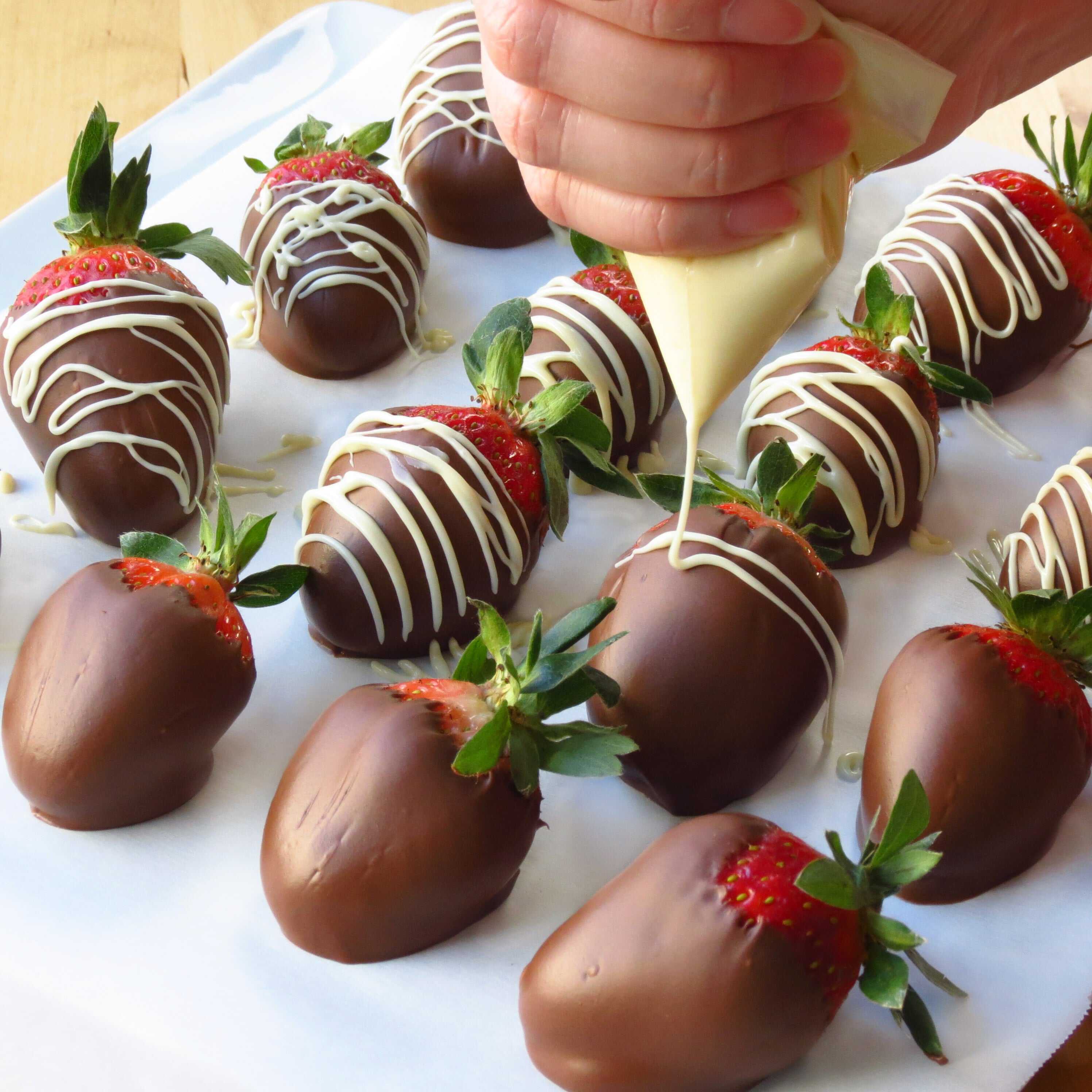 Drizzling white chocolate onto Chocolate Covered Strawberries