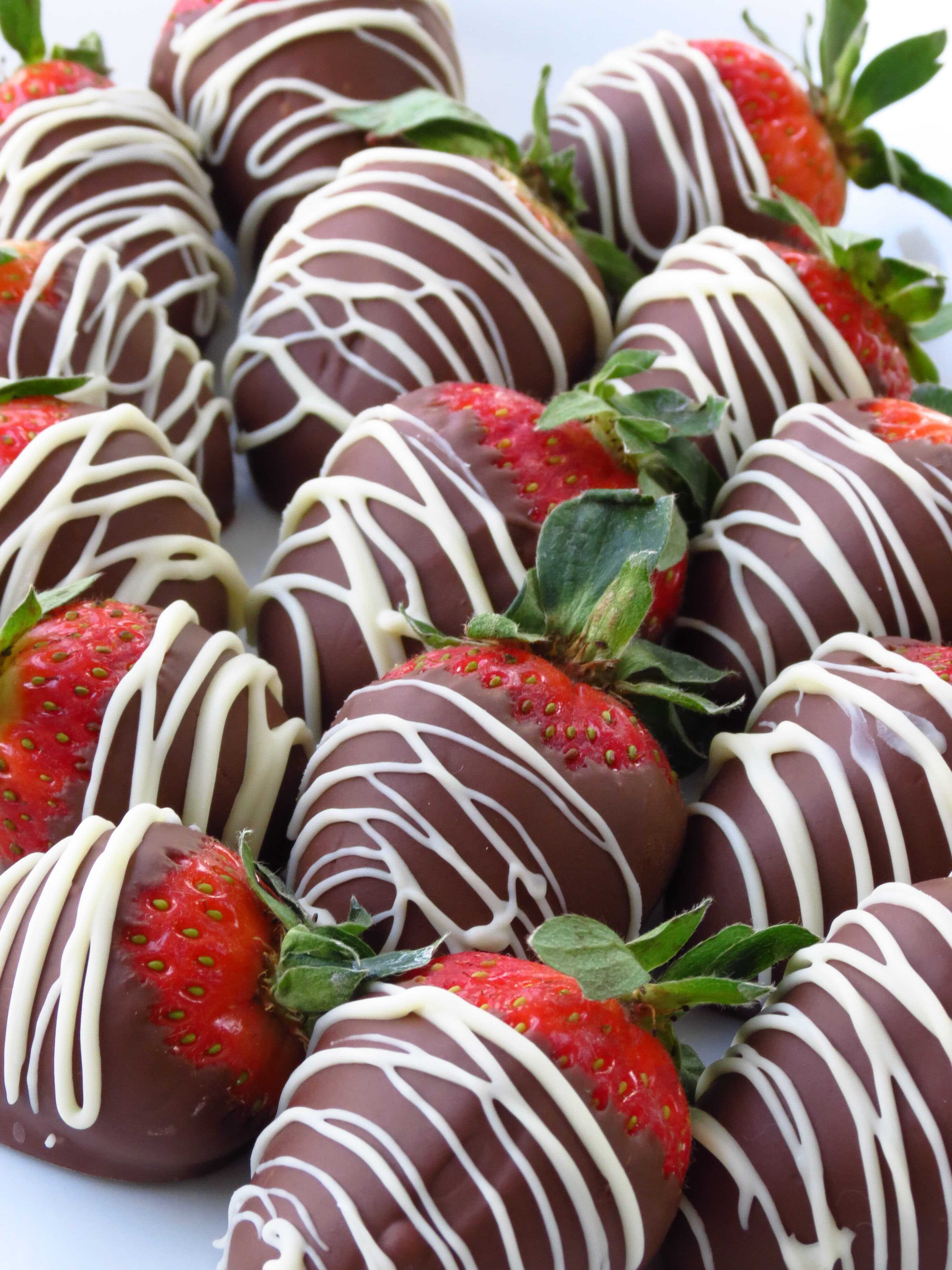 A bunch of Chocolate Covered Strawberries on a plate