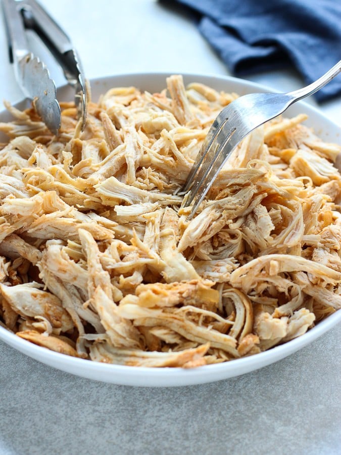 Shredding chicken to make Chicken Enchilada Casserole