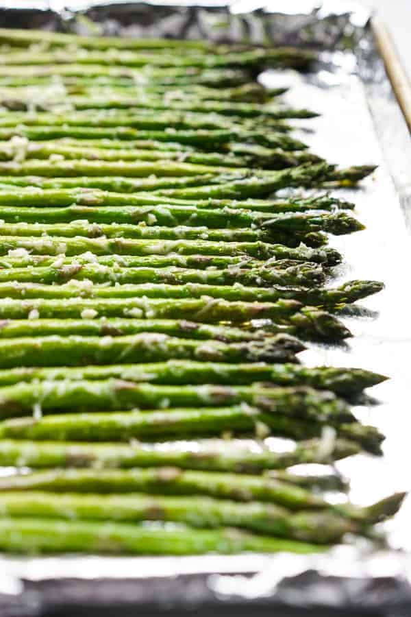 Coat asparagus with olive oil, garlic and parmesan cheese 