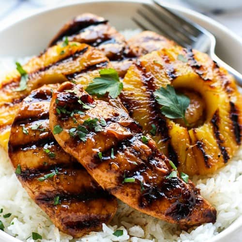 A bowl of Hawaiian Chicken and pineapple on top of a bed of Coconut Rice