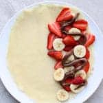 Fill crepes with strawberry, banana and nutella on one side
