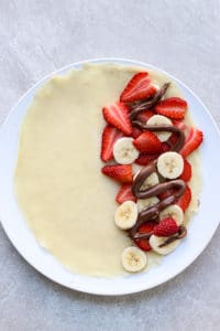 Fill crepes with strawberry, banana and nutella on one side