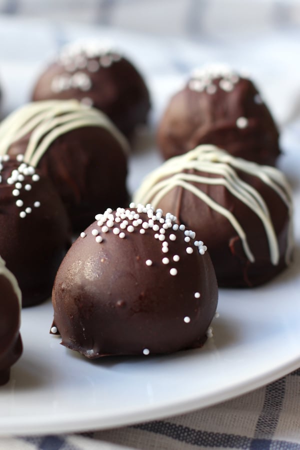 Close up of oreo balls coated in chocolate top with white sprinkles