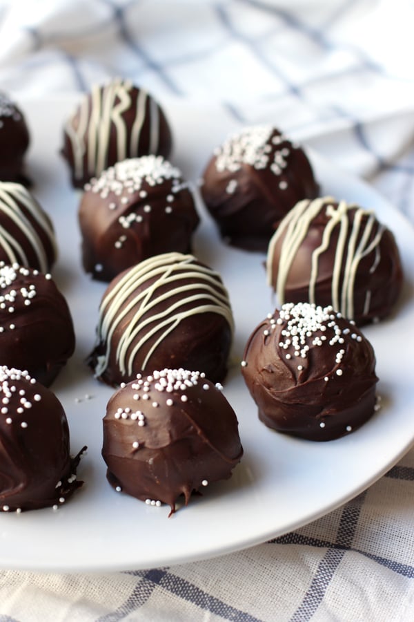 a plate full of Oreo truffles with decorations on top