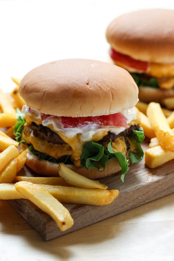 Burger with fries and another burger in the background