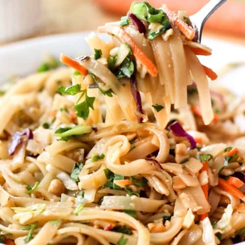 Using a fork to lift up noodles from a bowl