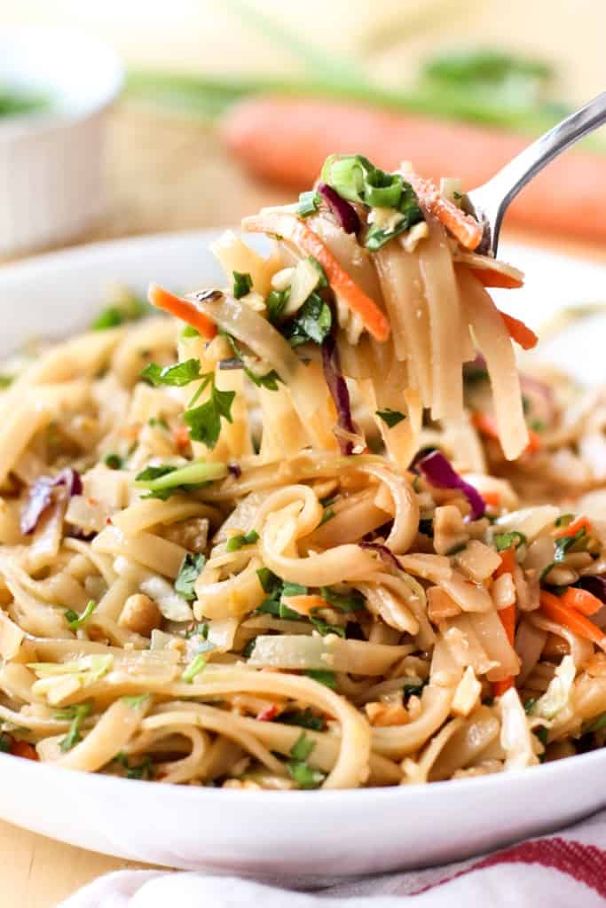Using a fork to lift up noodles from a bowl