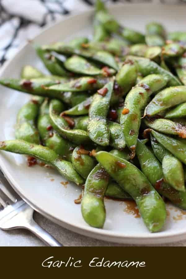 Garlic Edamame - An easy, healthy Asian-Inspired low carb veggie side or appetizer! Edamame sautéed and coated in a sticky, garlicky soy based sauce. 10 minutes from start to finish! The perfect way to kick off sushi or any Asian-inspired meal! Vegan and vegetarian. via @joyousapron