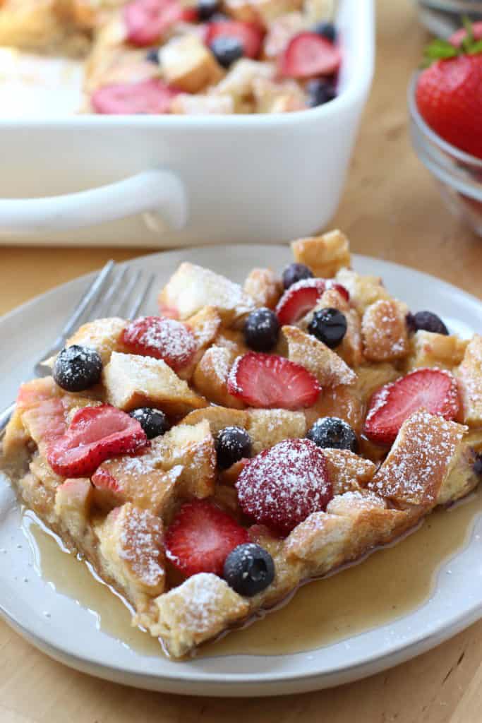 Berry French Toast Casserole topped with maple syrup