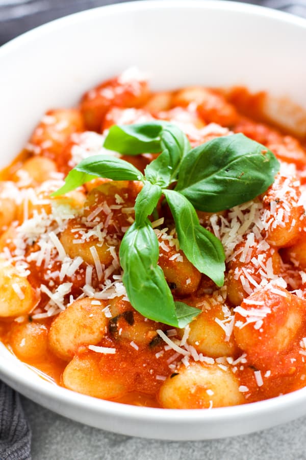 Close up of Gnocchi in tomato sauce with fresh basil on top