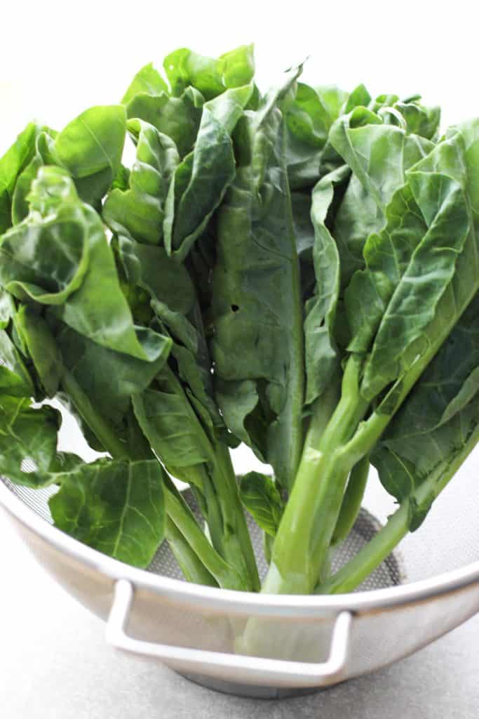 Chinese broccoli (gai lan) in a colander