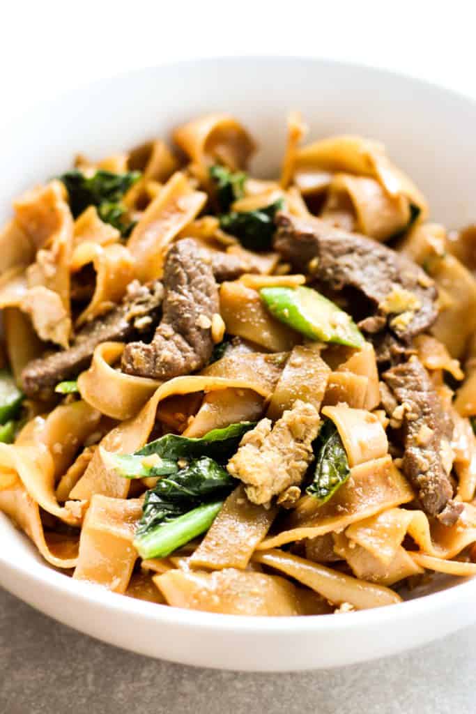 A bowl of pad see ew with strips of beef