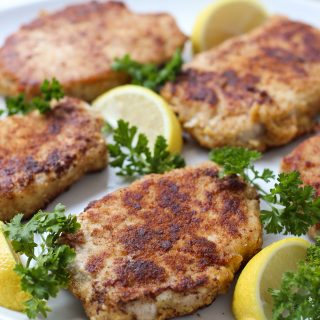 A plate of Lemon Butter Parmesan Crusted Pork Chops