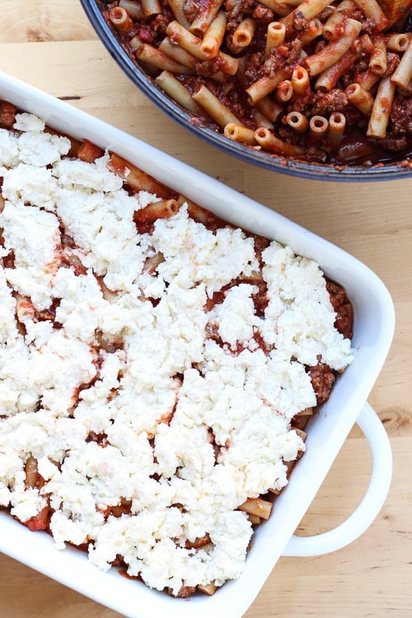 Layering the ziti, sauce and cheese filling