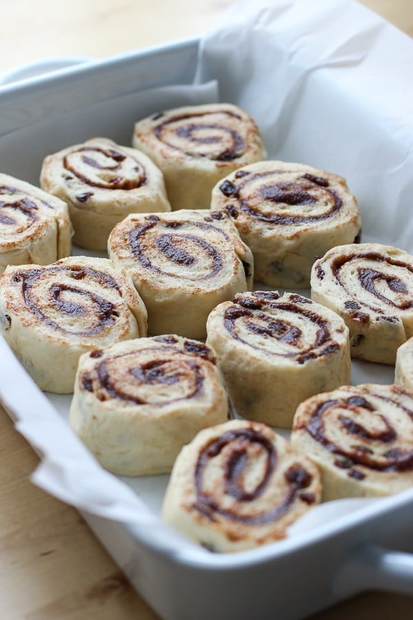 Unbaked Cinnamon Raisin Rolls in a large rectangular casserole dish