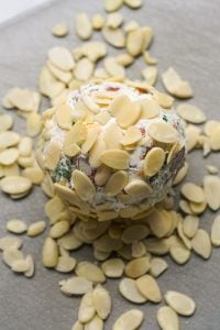 Coating cheeseball with shaved almonds