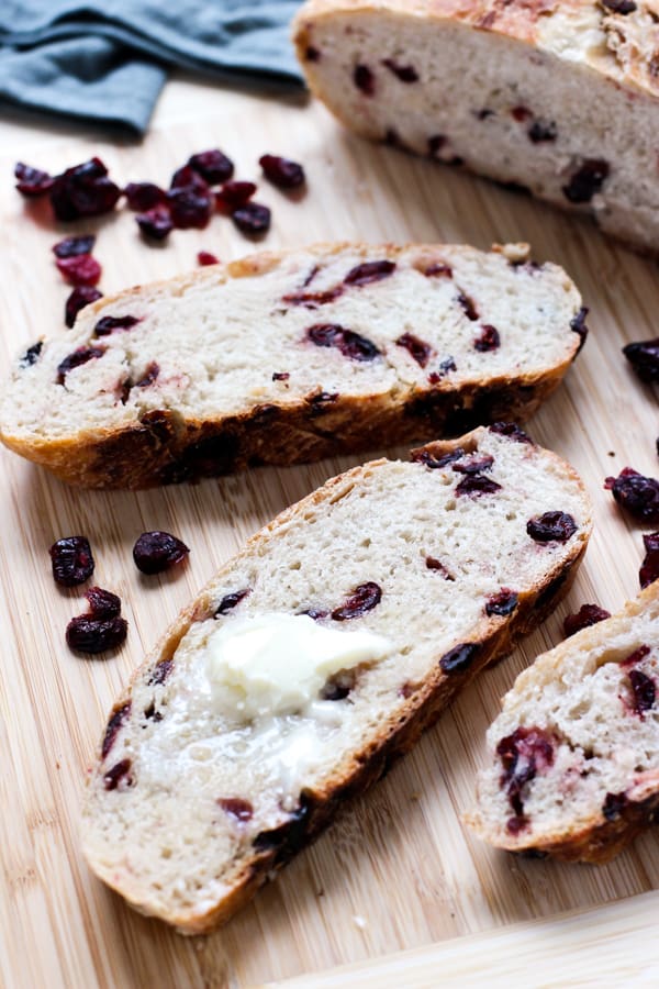 Butter on a slice of No-Knead Cranberry Bread