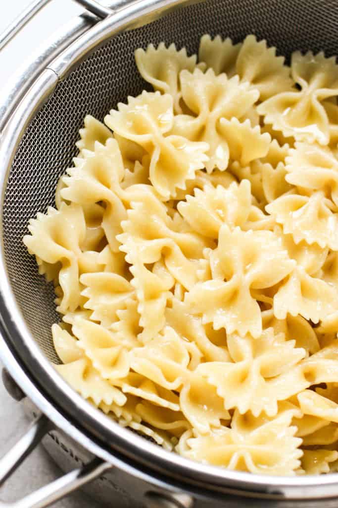 cooked bow tie pasta in strainer