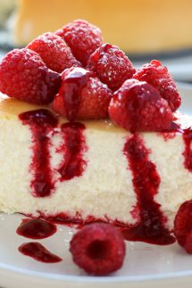A slice of crustless cheesecake with raspberries on top