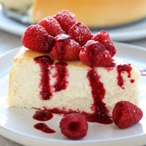 A slice of crustless cheesecake with raspberries on top