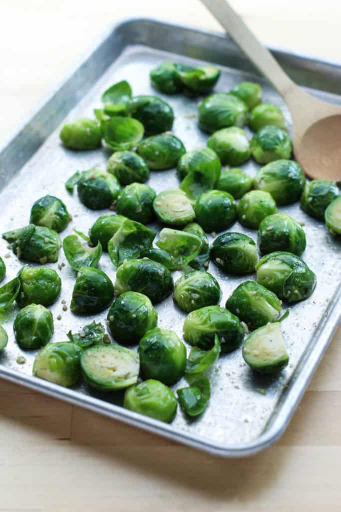 Halved Brussels sprouts on a baking sheet