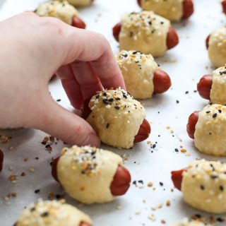 Grabbing a Pigs in the Blanket fresh from the oven