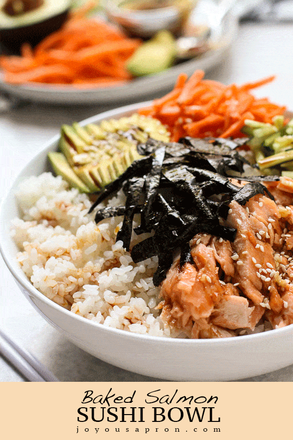 Baked Salmon Sushi Bowl - A deconstructed sushi bowl filled with seasoned sushi rice, topped with baked salmon, carrot cucumber, avocado, and crunchy dried seaweed, topped with sweet umami sauce. Perfect homemade meal to satisfy all your sushi cravings! via @joyousapron