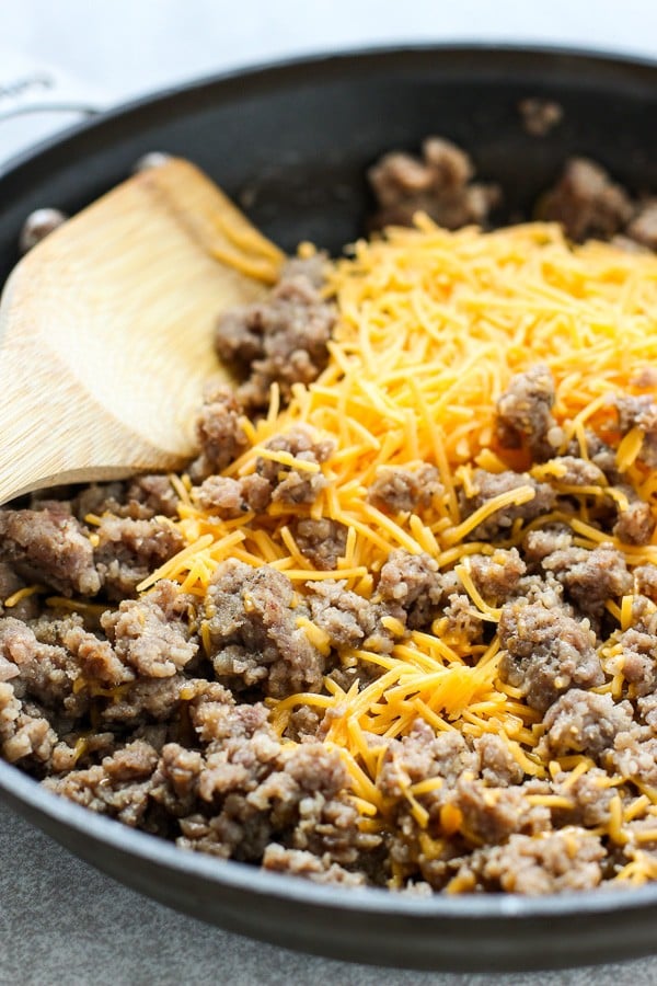 Cooking sausage and cheese in skillet for Sausage and Cheese Puff Pastry Pockets