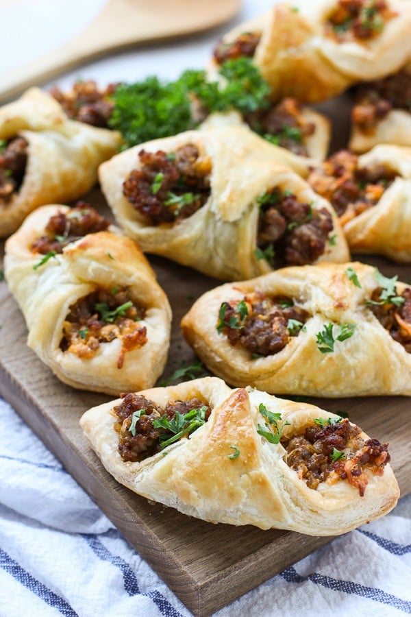 Sausage and Cheese Puff Pastry Pockets on a cutting board