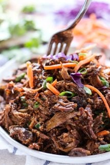 Slow Cooker Asian Shredded Pork on a plate, with a fork digging into it