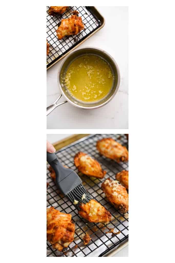 Brushing garlic butter sauce onto wings