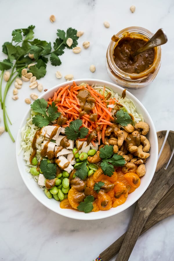 Top down view of Asian Peanut Chicken Salad drizzled with dressing