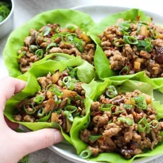 hand grabbing one of the Asian Lettuce Wraps