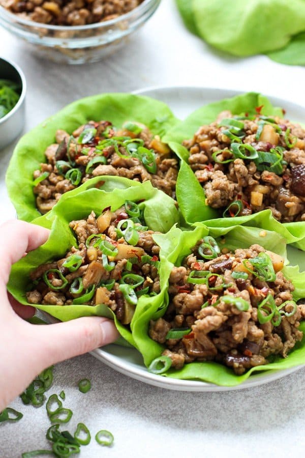 hand grabbing one of the Asian Lettuce Wraps