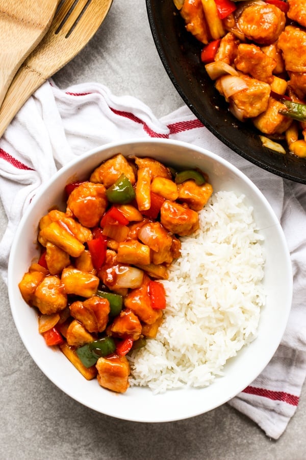 Top down picture of a bowl of Sweet and Sour Chicken with rice