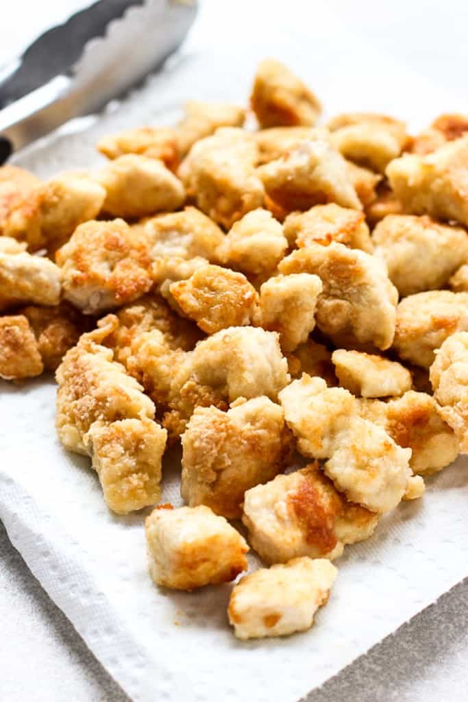 Crispy breaded chicken pieces on a plate lined with paper towel