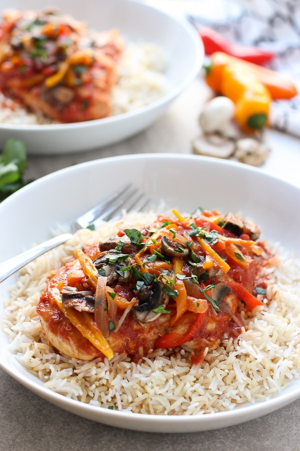 Two plates of Slow Cooker Tomato and Herb Chicken on rice