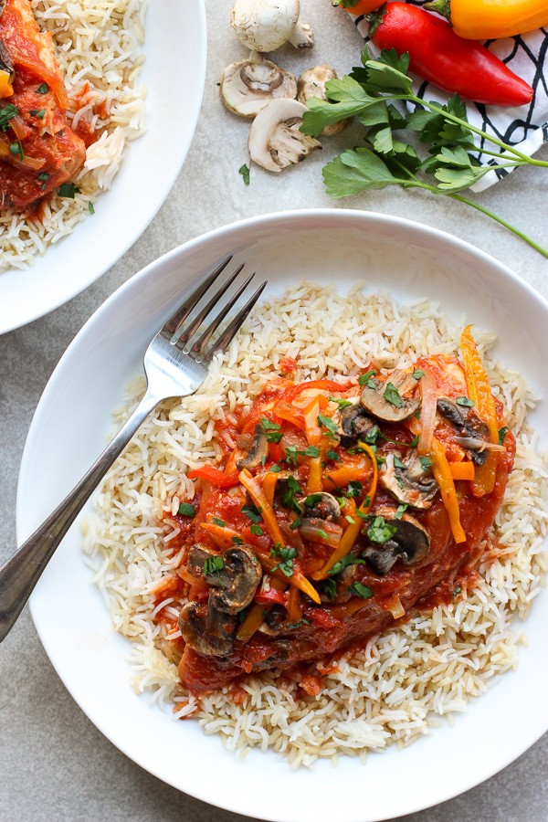 Slow Cooker Tomato and Herb Chicken on top of a bed of rice
