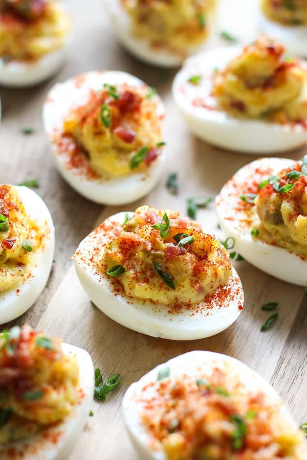 Upclose shot of Bacon Deviled Eggs on a wooden board