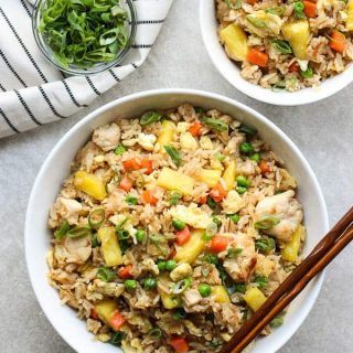 A large bowl and a small bowl of Thai Pineapple Fried Rice